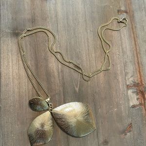 Long gold necklace with leave shape pendant